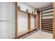Spacious walk-in closet under construction with custom wood shelving and hanging racks, ready for your wardrobe at 8809 Barium Rock Ave, Las Vegas, NV 89143