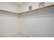 Simple walk-in closet under construction featuring wood hanging racks and drywall at 8809 Barium Rock Ave, Las Vegas, NV 89143