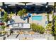 Aerial view of a community with a swimming pool and palm trees at 9050 W Tropicana Ave # 1102, Las Vegas, NV 89147