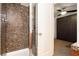 Bathroom with shower and views of the bedroom featuring a murphy bed at 9050 W Tropicana Ave # 1102, Las Vegas, NV 89147