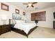 Comfortable bedroom with plantation shutters, ceiling fan, and plush carpet at 9050 W Tropicana Ave # 1102, Las Vegas, NV 89147