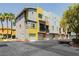 Exterior view of colorful modern townhomes with garages and well-maintained landscaping at 9050 W Tropicana Ave # 1102, Las Vegas, NV 89147