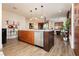 Open concept kitchen with modern island, stainless appliances, and hardwood floors at 9050 W Tropicana Ave # 1102, Las Vegas, NV 89147