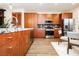 Modern kitchen featuring granite countertops, stainless steel appliances, and wood cabinetry at 9050 W Tropicana Ave # 1102, Las Vegas, NV 89147