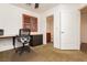 Bright office space with built-in desk and shelving leading to an ensuite bathroom at 9050 W Tropicana Ave # 1102, Las Vegas, NV 89147