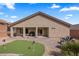 Landscaped backyard featuring a putting green, brick patio, and gravel groundcover at 942 Shadow Hawk Rdg, Mesquite, NV 89027