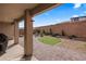 Landscaped backyard featuring a covered patio, putting green, and desert landscaping at 942 Shadow Hawk Rdg, Mesquite, NV 89027