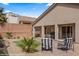 Landscaped backyard featuring a putting green, brick patio, and gravel groundcover at 942 Shadow Hawk Rdg, Mesquite, NV 89027