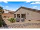 Landscaped backyard featuring a putting green, brick patio, and gravel groundcover at 942 Shadow Hawk Rdg, Mesquite, NV 89027