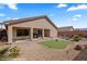 Landscaped backyard featuring a putting green, brick patio, and gravel groundcover at 942 Shadow Hawk Rdg, Mesquite, NV 89027