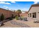 Landscaped backyard featuring a putting green, brick patio, and gravel groundcover at 942 Shadow Hawk Rdg, Mesquite, NV 89027