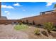 Landscaped backyard featuring a putting green, brick patio, and gravel groundcover at 942 Shadow Hawk Rdg, Mesquite, NV 89027