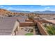 Private backyard featuring a putting green, patio area with lounge chairs, and desert landscaping at 942 Shadow Hawk Rdg, Mesquite, NV 89027
