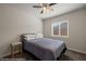 Cozy bedroom with a ceiling fan, window, comfortable bed, and neutral decor at 942 Shadow Hawk Rdg, Mesquite, NV 89027