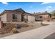 Attractive single-story home featuring desert landscaping, a tile roof and an attached two-car garage at 942 Shadow Hawk Rdg, Mesquite, NV 89027
