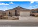 Charming single-story home featuring desert landscaping, a tile roof and an attached two-car garage at 942 Shadow Hawk Rdg, Mesquite, NV 89027