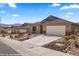 Charming single-story home featuring desert landscaping, a tile roof and an attached two-car garage at 942 Shadow Hawk Rdg, Mesquite, NV 89027