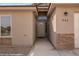Covered front entry with stone accents and desert landscaping at 942 Shadow Hawk Rdg, Mesquite, NV 89027