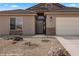 Covered front entry with stone accents and desert landscaping at 942 Shadow Hawk Rdg, Mesquite, NV 89027