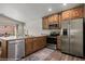 Well-equipped kitchen with stainless steel appliances, granite counters, and wooden cabinets at 942 Shadow Hawk Rdg, Mesquite, NV 89027