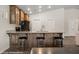 Kitchen featuring a breakfast bar with wood accents and granite countertops at 942 Shadow Hawk Rdg, Mesquite, NV 89027