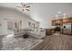 Open-concept living room and kitchen featuring lots of room, wood floors and vaulted ceiling at 942 Shadow Hawk Rdg, Mesquite, NV 89027
