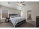 Serene main bedroom with a patterned bedspread, ceiling fan, and carpeted floors at 942 Shadow Hawk Rdg, Mesquite, NV 89027