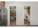 Walk-in pantry provides ample storage adjacent to a laundry area with modern appliances at 942 Shadow Hawk Rdg, Mesquite, NV 89027