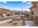 Neighborhood street view with well-maintained desert landscaping, attractive homes, and mountain views at 942 Shadow Hawk Rdg, Mesquite, NV 89027