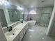 Modern bathroom showcasing dual sinks, a soaking tub, and a separate glass-enclosed shower at 10574 Salmon Leap St, Las Vegas, NV 89183