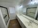Bright bathroom featuring a double sink vanity, tile floors, and glass shower enclosure at 10574 Salmon Leap St, Las Vegas, NV 89183
