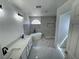 Bright bathroom with a double sink vanity, a luxurious soaking tub, and tiled shower at 10574 Salmon Leap St, Las Vegas, NV 89183