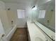 Bright bathroom with a double sink vanity, and a shower/tub combo at 10574 Salmon Leap St, Las Vegas, NV 89183