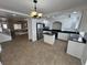Open-concept kitchen with stainless steel appliances, granite countertops, and an island at 10574 Salmon Leap St, Las Vegas, NV 89183
