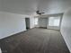 Expansive living room with plush carpeting, natural light, and a ceiling fan for added comfort at 10574 Salmon Leap St, Las Vegas, NV 89183