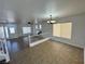 Open-concept living area with staircase and modern lighting with the front door visible at 10574 Salmon Leap St, Las Vegas, NV 89183