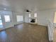 Spacious living room with tile flooring, fireplace, ceiling fan, and modern front door at 10574 Salmon Leap St, Las Vegas, NV 89183