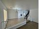 Open-concept living area with staircase, tile flooring, and a view of the lower level at 10574 Salmon Leap St, Las Vegas, NV 89183