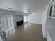 Loft view of the living area with fireplace, tile flooring, and natural light from windows at 10574 Salmon Leap St, Las Vegas, NV 89183