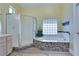 Bathroom showcases a glass enclosed shower and a tiled tub with a glass block window at 10632 Clarion Ln, Las Vegas, NV 89134