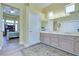 Light filled bathroom features a dual sink vanity and ample storage space at 10632 Clarion Ln, Las Vegas, NV 89134