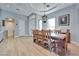 View of the dining area with wood floors, tray ceiling, and a large wooden table with a chandelier at 10632 Clarion Ln, Las Vegas, NV 89134