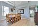 Bright dining room with wood floors, and a large wooden table with ornate legs and a hanging chandelier at 10632 Clarion Ln, Las Vegas, NV 89134