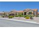 Charming single-story home with a tile roof, desert landscaping, and an attached two-car garage at 10632 Clarion Ln, Las Vegas, NV 89134