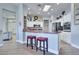 Bright kitchen features white cabinets, a skylight, stainless steel appliances, and an island with a breakfast bar at 10632 Clarion Ln, Las Vegas, NV 89134