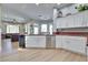 Spacious kitchen with stainless steel appliances, red granite countertops, and light wood floors at 10632 Clarion Ln, Las Vegas, NV 89134