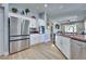 Open kitchen design featuring stainless steel appliances, white cabinetry, and spacious layout at 10632 Clarion Ln, Las Vegas, NV 89134