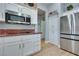 Bright kitchen featuring stainless steel appliances, white cabinetry, and stone countertops at 10632 Clarion Ln, Las Vegas, NV 89134