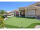 Green backyard featuring an outdoor putting green and landscaped areas for recreation at 10632 Clarion Ln, Las Vegas, NV 89134