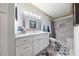 Beautiful bathroom with a white vanity, shower with stone tiling and a built-in bench at 1150 N Buffalo Dr # 1007, Las Vegas, NV 89128